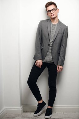 Takım elbiseli ve gözlüklü zeki bir gencin portresi. Stüdyo çekimi. Erkek güzelliği. Eğitim, eğitim..