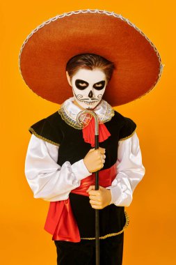 Parlak sarı arka planda şeker kafalı yakışıklı bir çocuğun portresi. Cadılar Bayramı. Dia de los muertos. Ölüler günü. Boşluğu kopyala.