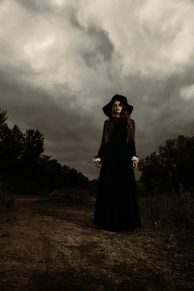A portrait of a lonely dark witch near the forest. Magic, dark force, spell.