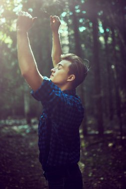 Vahşi ormanda yakışıklı, erkeksi bir adam. Macera, özgürlük ruhu. Etkin yaşam biçimi. 
