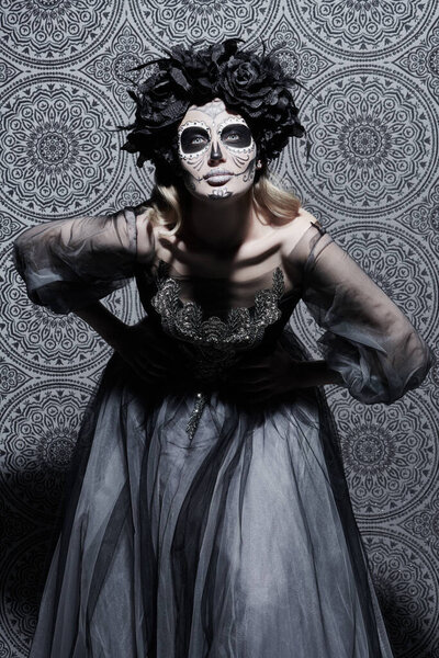 Beautiful Calavera Catrina over vintage background. Fashion model with sugar skull makeup. Dia de los muertos. Day of The Dead. Halloween.
