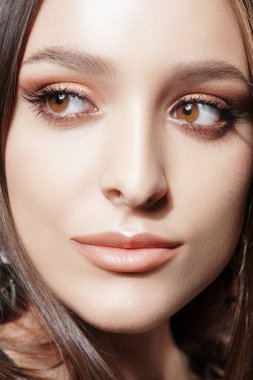 Makyaj ve makyaj malzemeleri. Kahverengi makyajlı güzel bir esmer kızın yakın plan portresi..