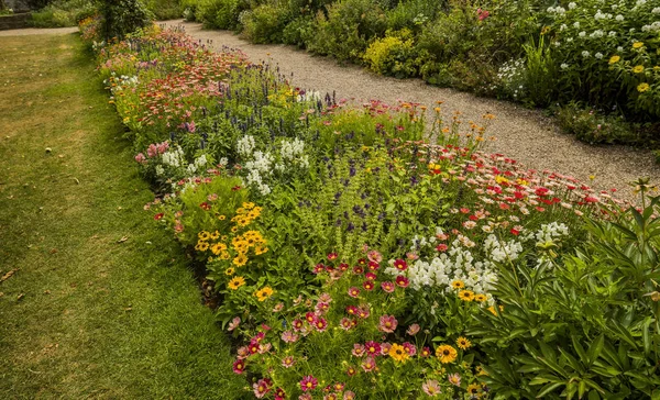 English country cottage garden  with flowers of stately home