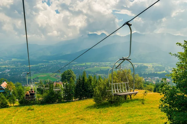 beautiful view of the valley with houses and mountains from the ski lift during the descent