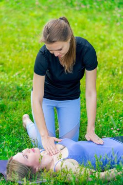 deneyimli eğitmen bir yoga sınıf sırasında nefes womans denetler