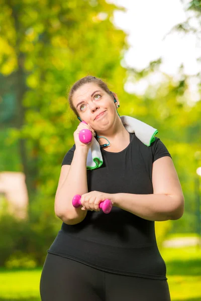 Modelos sonrientes más de tamaño haciendo ejercicios con mancuernas durante un —  Fotos de Stock