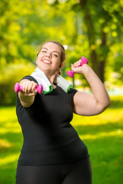 Vertical portrait of a happy oversized woman in headphones with — Stock Photo, Image