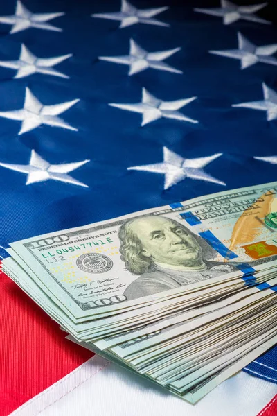 Vista di un mucchio di soldi che giacciono sulla bandiera degli Stati Uniti — Foto Stock