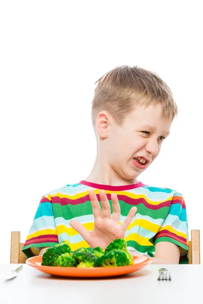10-year-old boy refuses a plate of broccoli for lunch, concept p — Stock Photo, Image