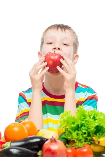 O menino come uma maçã suculenta vermelha, retrato em um fundo branco — Fotografia de Stock