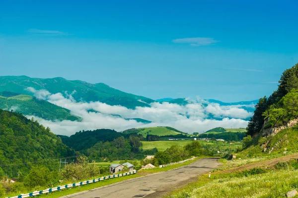 Clouds in the mountains of Armenia, cover the valley on a sunny