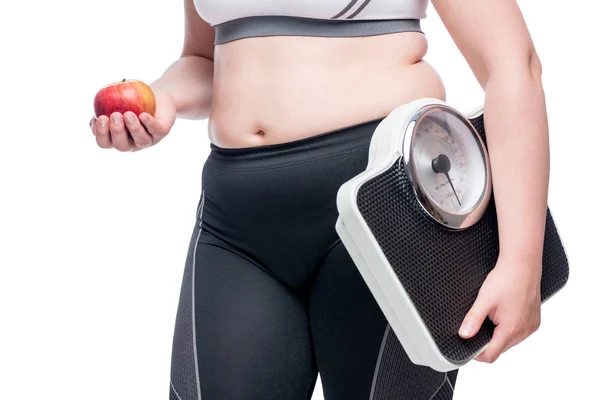 Woman with scales and apple makes a choice in favor of sports an — Stock Photo, Image