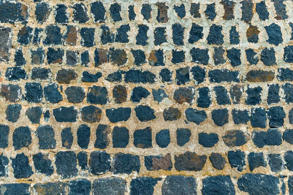 Background black stone walls of an ancient monastery close up — Stock Photo, Image