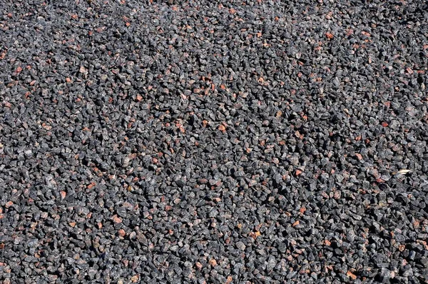 Ezilmiş taş granit taş. Portakal parçaları ile gri arka plan.