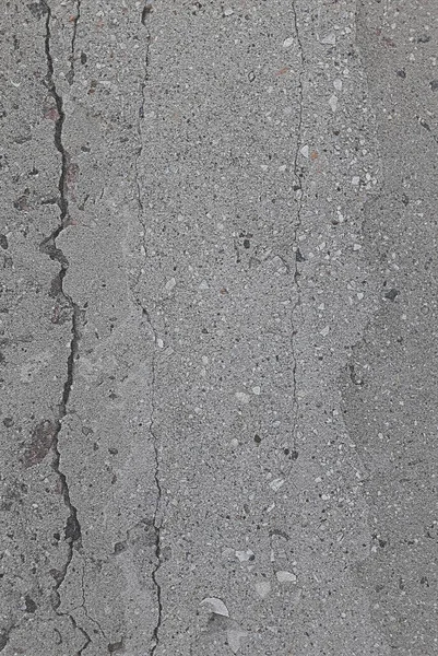 Background texture of concrete, gray with stone particles.Concrete cracks.