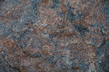 Doku doğal taş yakın çekim. Arka plan mavi ve kahverengi - kırmızı.