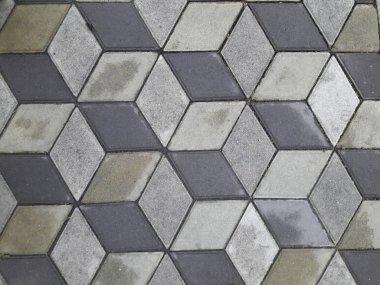 Yağmurdan sonra gri ve koyu gri kaldırım döşeme. Geometrik süsleme. Doku ve arka plan taş.