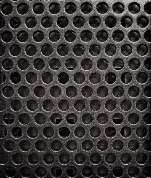 Grunge texture of metal sheet background with holes.