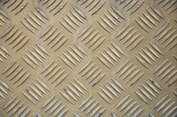 Metal texture background. Copper plate with a corrugated coating. Yellow metal.
