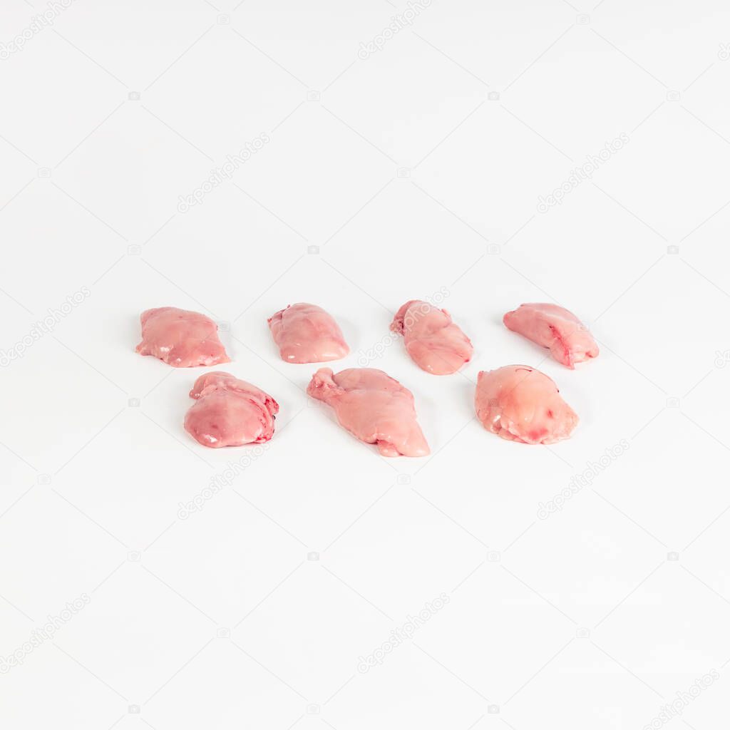 seven pieces of sweetbreads of suckling lamb , photograph taken on pure white background, for e-commerce. front view