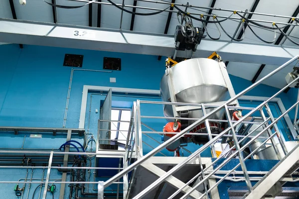 inside a modern wine cellar, stainless steel tanks