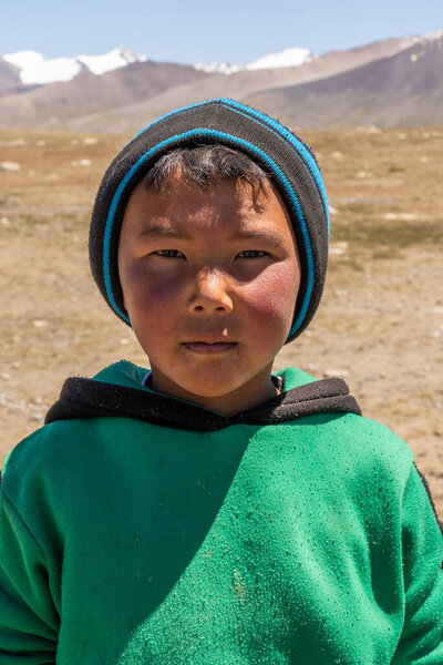 Jeti-Oguz, kyrgystan - July 11, 2019: Small boy in the Mountains of Kyrgystan in summertime with cap.