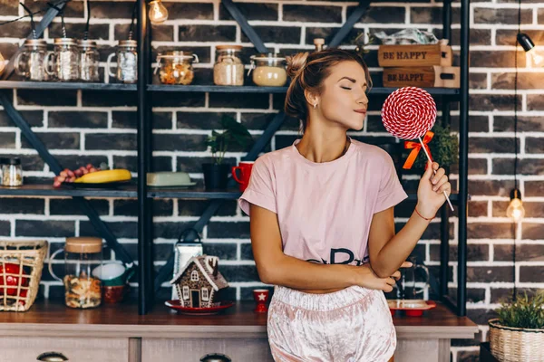 Onun elinde büyük bir lolipop Pembeli sarışın güzel kız