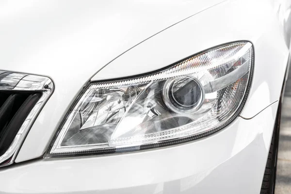 Modern and elegant white car - Closeup of car headlight — Stock Photo, Image