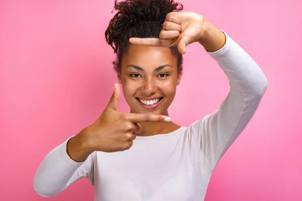 Närbild porträtt av en rolig mulatt flicka gör en gest kvadrat från fingrar-bild — Stockfoto