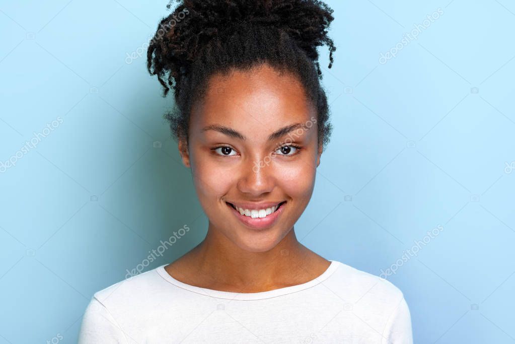 Closeup portrait of a charming mulatto girl over blue studio background- Image