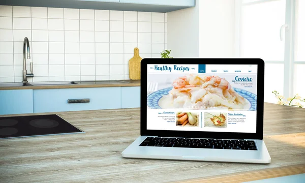 笔记本电脑与健康食谱网站在屏幕上的厨房 — 图库照片