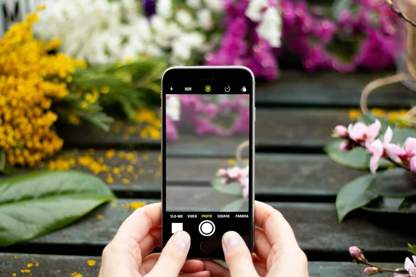 Mãos Com Smartphone Uma Cena Primaveral — Fotografia de Stock