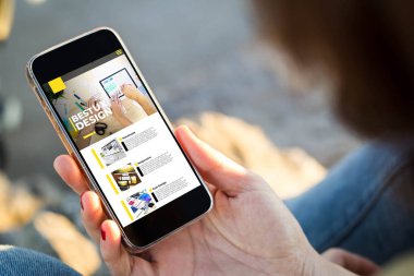 Genç bir kadının cep telefonuyla ux tasarım web sitesine göz attığı yakın plan görüntüler. Tüm ekran grafikleri uydurma.
