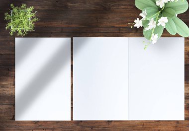 ahşap bir masa üzerinde bitkiler ile açık ve kapalı iki katlı broşür üst görünümü. 3d render mockup