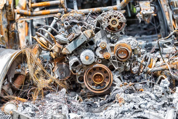 Burned and rusty engine from a damaged car