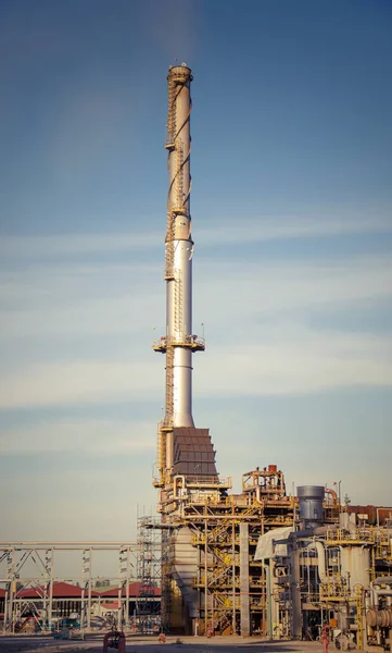 The modern factory smokestacks of the industry on the blue sky o — Stock Photo, Image