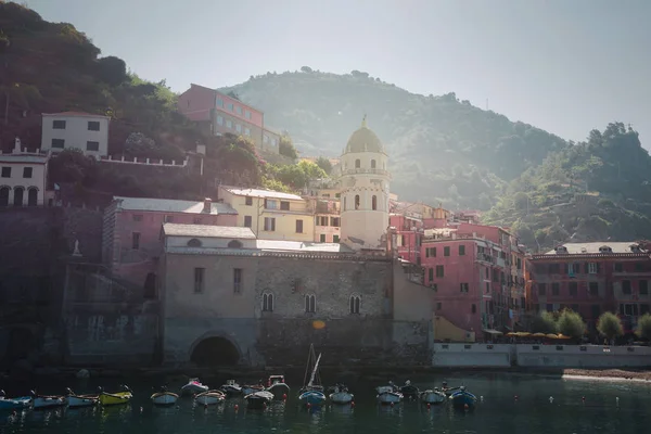 Vernazza, İtalya, La Specia Eyaleti, Liguria Regione, 08 Ağustos, 2018: görünümü, Cinque Terre'nin sahil şeridi boyunca renkli evleri '. Sabah güneş ışınlarının içinde Vernazza içinde İskele Balık tutma.