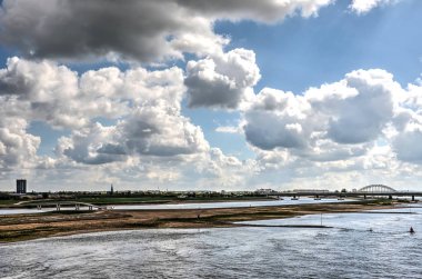 The river Waal, the adjacent floodplains and the new river channel under a dramatic sky clipart