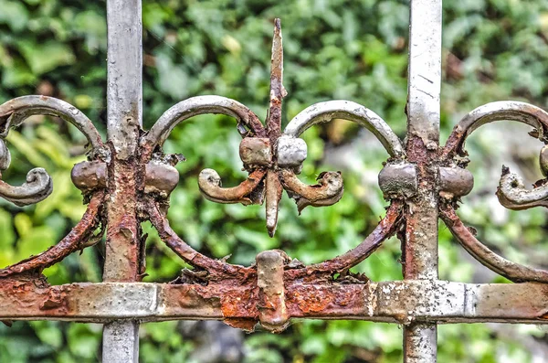 Rust on an old decorated steel fence in a forest environment in Valkenburg, The Netherlands