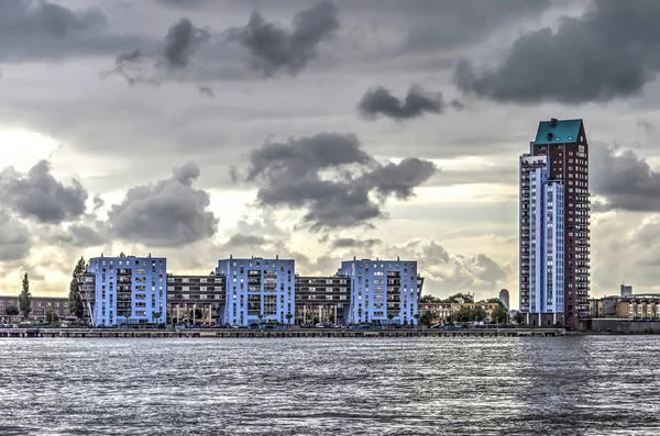 Modern/post modern apartment buildings at the waterfront of the suburb of Bolnes near Rotterdam under a dramtic sky