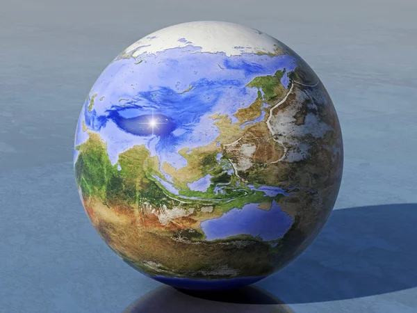 Globe of an inverted earh on which land and water are reversed, with sunlight from the left, on a shiny surface, looking at the hemisphere of the Asian ocean and Australian sea