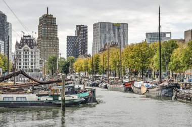 Rotterdam, Hollanda, 17 Ekim 2019: Haringvliet limanında tarihi mavnalar, şehrin silueti ile kaplı, arka planda Beyaz Saray 'ı suçlayan,