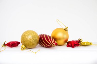 Beyaz arka plan yakın üst üste üzerinde altın ve kırmızı Noel ağacı süslemeleri