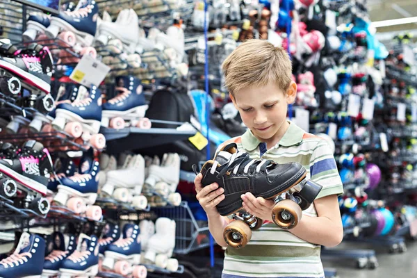 Мальчик с роликами в магазине — стоковое фото