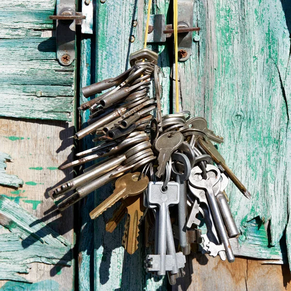 绿色复古墙背景上的一堆旧钥匙 — 图库照片