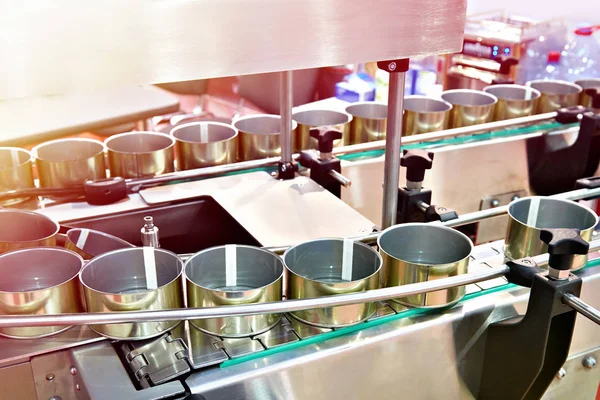 Empty cans on the conveyor of a food factory