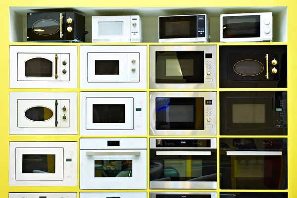 Microwave ovens on display at store — Stock Photo, Image