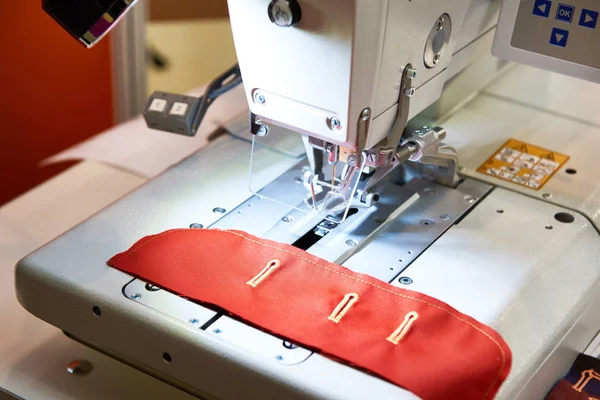 Sewing machine with red cloth — Stock Photo, Image