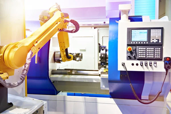 Robotic arm and cnc lathe — Stock Photo, Image