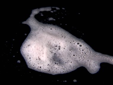 soap foam isolated on black background clipart